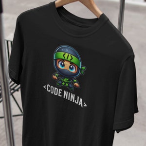 May include: Black t-shirt featuring a cartoon ninja wearing a green headband with the text "< >" on it. The text "<CODE NINJA>" is below the ninja.