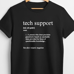 Puede incluir: Camiseta negra con la frase "tech support" en blanco y una definición. La definición describe el soporte técnico como una persona que hace conjeturas de precisión basadas en datos poco fiables. Ver también: wizard, magician.