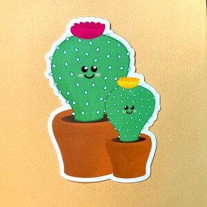 Pegatina de vinilo con un lindo cactus sonriente y flores