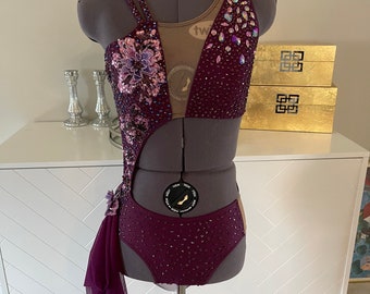 Purple/Plum lyrical solo dance costume with beautiful 3-D appliqués. AAdance base Made to order (no refund or exchange). Ships in 6-8 weeks.