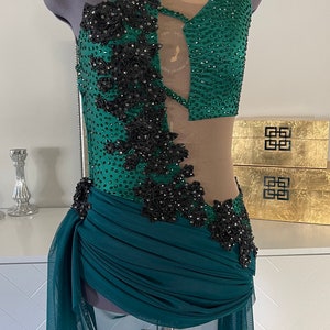 Beautiful green lyrical one shoulder costume with tons of black diamonds and black crystals in different sizes. Stunning Appliqués and skirt