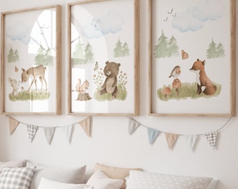 May include: Three framed wall art prints featuring watercolor forest animals including a deer, bear, and fox, displayed above a wooden storage bench with white bins and various patterned throw pillows, next to a tall woven giraffe figure.