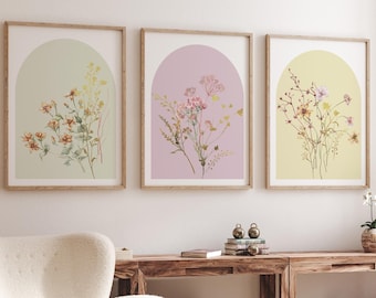 May include: Three framed prints with a light green, light pink, and light yellow background. Each print features a watercolor illustration of a bouquet of flowers with an arched opening at the top.