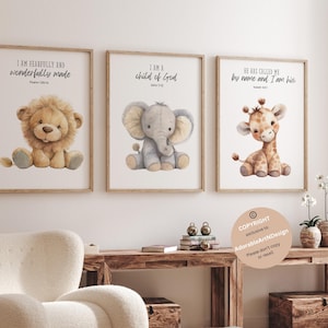 May include: Three watercolor prints featuring a lion, elephant, and giraffe with inspirational quotes. The lion print says "I am fearfully and wonderfully made", the elephant print says "I am a child of God", and the giraffe print says "He has called me by name and I am his".