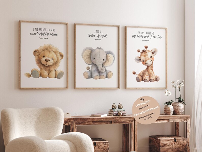 May include: Three watercolor prints featuring a lion, elephant, and giraffe with inspirational quotes. The lion print says "I am fearfully and wonderfully made", the elephant print says "I am a child of God", and the giraffe print says "He has called me by name and I am his".