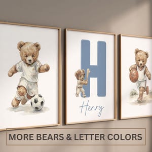 May include: Three framed wall art prints featuring watercolour-style teddy bears in sports attire. The left print shows a bear playing football, the centre print displays a large blue letter H with a baseball bear and the name Henry, and the right print shows a bear dribbling a basketball.