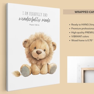 May include: A white canvas print with a cute cartoon lion cub sitting with a quote that reads "I am fearfully and wonderfully made" and the scripture reference "Psalm 139:14".