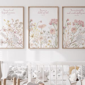 May include: Three framed wall art prints featuring watercolour-style wildflowers in shades of pink, yellow, and green. Each print includes inspirational text: You are loved beyond measure, You are a child of God, and You are fearfully and wonderfully made.