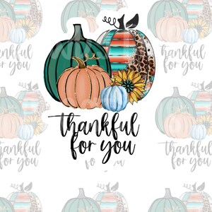 May include: A sticker sheet with a design of three pumpkins. The pumpkins are teal, orange, and blue. The text "Thankful for you" is written in a decorative font below the pumpkins.