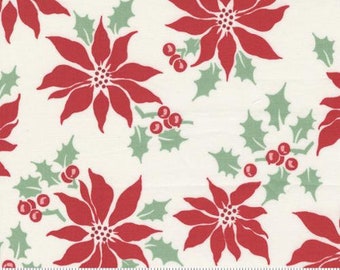 May include: White fabric with a repeating pattern of red poinsettia flowers and green holly leaves. The fabric has a "moda" label with the website address "www.modafabrics.com".