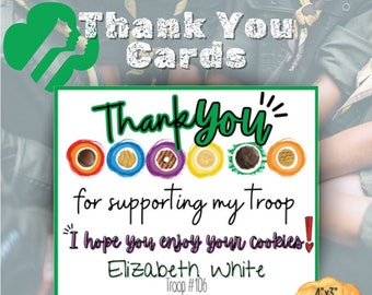May include: A printable thank you card for Girl Scout cookie sales. The card features a colorful design with Girl Scout cookie logos and the text "Thank You!"  "for supporting my troop" "I hope you enjoy your cookies!"  "Elizabeth White"  "Troop #106"