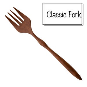 May include: A wooden fork with four tines and a long handle. The fork is a dark brown color and has the text "Classic Fork" in a black font.