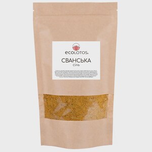 May include: A brown paper bag with a clear window showing a yellow spice blend. The bag has a white label with the text "ecolotos." and "SVANSKA SIL" in black.