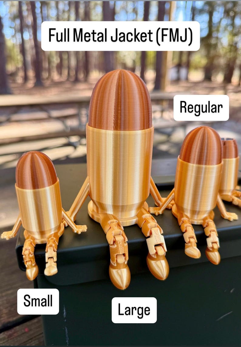 May include: Three gold-coloured, 3D printed bullet figurines, each with articulated legs. The figurines are labelled "Small", "Large", and "Regular". The text "Full Metal Jacket (FMJ)" is at the top of the image.
