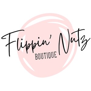 May include: A pink circle with a white outline and the text "Flippin' Nutz Boutique" in black cursive writing.