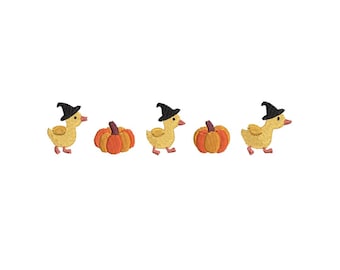 May include: An embroidery design featuring three yellow ducklings wearing black pointed hats, alternating with two orange pumpkins. The ducks have orange beaks and feet, while the pumpkins feature brown stems and vertical textured stitching.