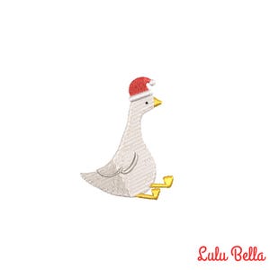 May include: White goose wearing a red Santa hat with yellow feet. The goose is sitting down with its head turned to the right.