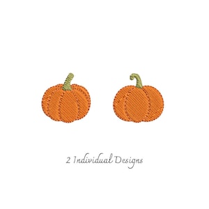 May include: Two embroidered pumpkin designs featuring orange thread for the pumpkin body and green thread for the stem. The pumpkins are rendered with visible stitching patterns and are accompanied by the text 2 Individual Designs.