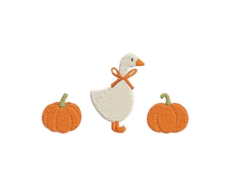May include: An embroidery design featuring a white goose with an orange beak and feet, wearing an orange ribbon around its neck, positioned between two orange pumpkins with green stems, all rendered in a textured stitch pattern.