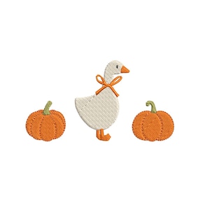 May include: An embroidery design featuring a white goose with an orange beak, orange feet, and an orange ribbon tied around its neck, positioned between two orange pumpkins with green stems, all rendered in a textured stitch pattern.