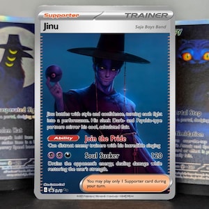 May include: A Trainer card featuring "Jinu" from the Saja Boys Band. The card depicts a character in a black hat and dark clothing, holding a purple orb. The card text includes "Join the Pride" and "Soul Sucker" abilities.