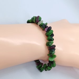 Peut inclure: Un bracelet en pierres précieuses vertes, roses et noires, composé de pierres en forme d'éclats.