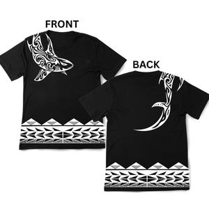 May include: Black t-shirts with white tribal designs. The front features a stylized whale, and the back has a curved tribal pattern. Both sides have a geometric border at the bottom. The word "FRONT" and "BACK" are printed on the image.