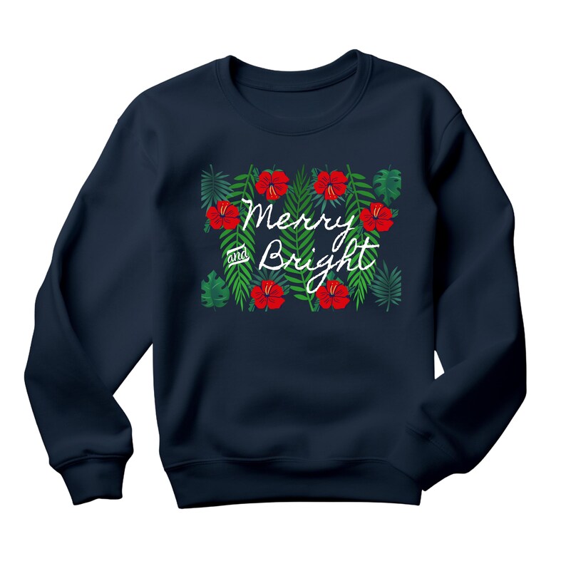 May include: Navy blue sweatshirt with a festive design. The design features red hibiscus flowers and green leaves, with the words "Merry and Bright" in white script. A cozy and stylish holiday apparel item.