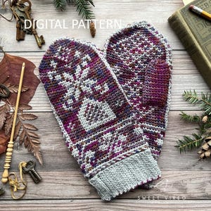 May include: A pair of knitted mittens with a geometric pattern in shades of purple, gray, and white. The mittens have a gray cuff and are displayed on a wooden surface with vintage keys and a book. The text "DIGITAL PATTERN" is visible.