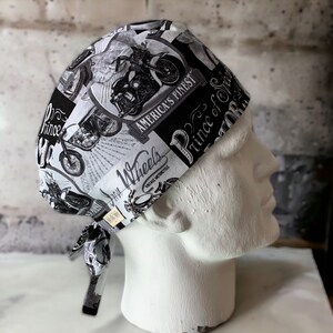 May include: Black and white patterned surgical scrub hat with a motorcycle theme. The hat features the text "America's Finest", "Wheels", and "Prince of Speed".