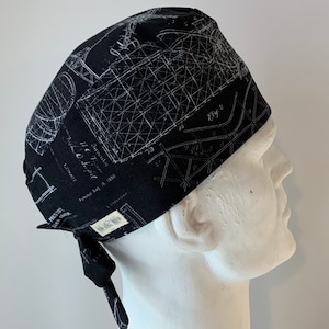 May include: Black scrub hat with a white print of a technical drawing. The drawing includes the text "Fig 2" and "Patented Aug 16, 1886".