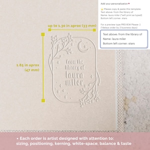 May include: A white bookplate with a decorative border featuring a crescent moon, stars, and floral elements. The text "from the library of laura miler" is printed in the centre. The bookplate measures 4.7 cm by 3.3 cm.