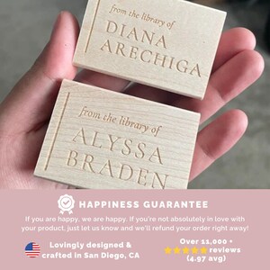 May include: Two wooden bookplates with the text "from the library of" followed by a name. The top bookplate reads "DIANA ARECHIGA" and the bottom bookplate reads "ALYSSA BRADEN".