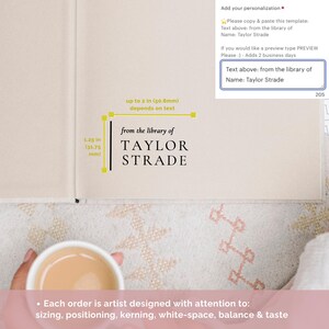 May include: A close-up of a book with a personalized inscription that reads "from the library of TAYLOR STRADE". The inscription is printed in black ink on a cream-colored page. The book is open to a blank page.