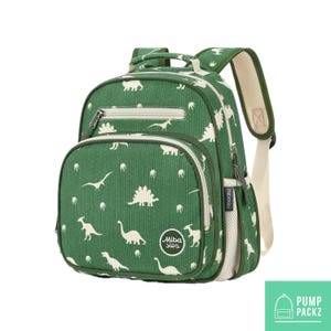 May include: Green corduroy backpack with a white dinosaur pattern. Features a front zippered pocket, side mesh pocket, and padded shoulder straps. The backpack has a top handle and a white interior lining. The brand name "Miba sles" is visible on the front.