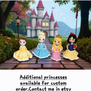 May include: Four handmade princess dolls in colorful dresses stand in front of a castle. The dolls include a princess in a yellow dress, a blue dress, a pink dress, and a Snow White doll. The word "PRINCESSES" is written in pink at the top.