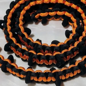 Orange and Black paracord DUCK WRANGLER rubber duck holder for jeeps.