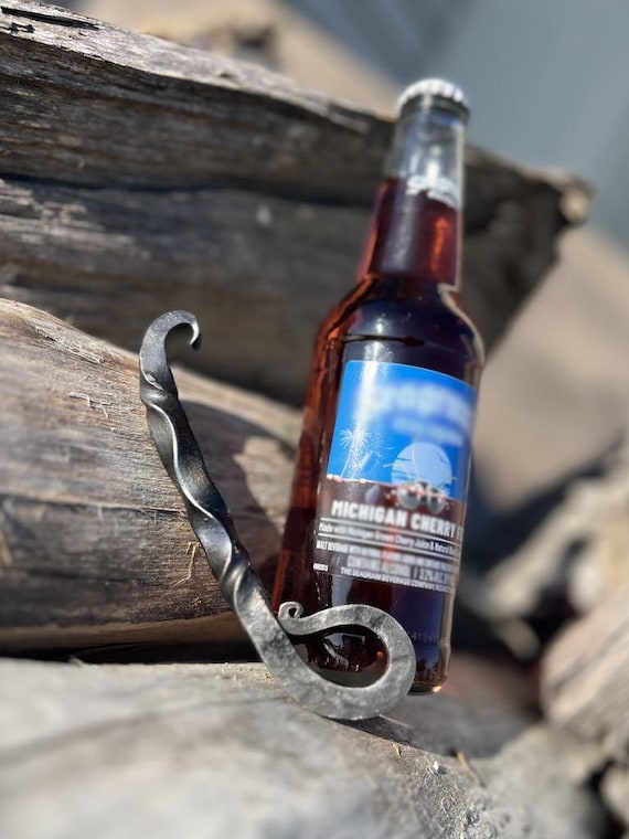 Another hand-forged blacksmith bottle opener — tied favorites with the listing above, but worth keeping as a variant; raw iron craft that feels genuinely one-of-a-kind.