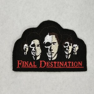 May include: Black embroidered patch with the text "Final Destination" in red. The patch features five white faces with black outlines, representing characters from the movie franchise.