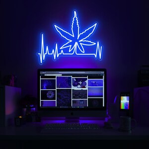 Glowing Green Neon Sign With Cannabis Leaf Symbol For A Medical Marijuana Dispensary Image622923976