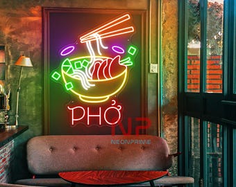 May include: Neon sign with a bowl of Pho noodles, chopsticks, and the word "PHO" in red, yellow, and green. The sign is hanging on a brick wall in a restaurant.