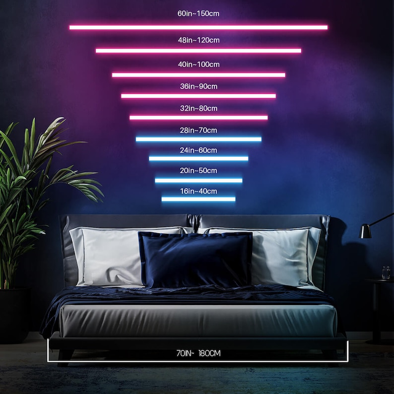 May include: A white bed frame with a grey mattress and blue pillows. The wall behind the bed is a dark blue with neon pink and blue lights that show different measurements in inches and centimetres. The text at the bottom of the image reads "70IN- 180CM".