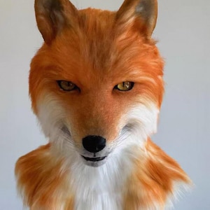 May include: A realistic fox head mask featuring vibrant orange and white fur, pointed ears, and amber-colored eyes. The mask includes a black nose and detailed facial features, covering the head and neck area with textured synthetic fur.