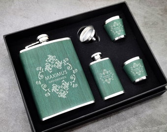 May include: A green metal flask with the text "MAXIMUS GROOMSMEN" engraved on it. The flask is in a black box with four shot glasses.