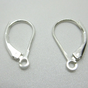 May include: A pair of silver earring hooks. The hooks are made of metal and have a smooth finish.