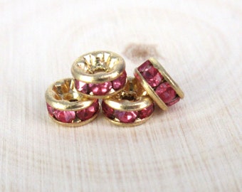 May include: Four gold-toned bead caps with a single row of pink rhinestones around the edge.