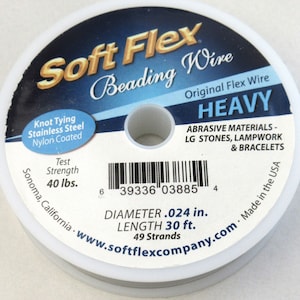 May include: A white spool of Soft Flex Beading Wire, labeled "Heavy" and "Original Flex Wire". The spool is 30 feet long and has a diameter of 0.024 inches. The wire is made of stainless steel and is nylon coated. The label also states that the wire is made in the USA and has a test strength of 40 lbs.