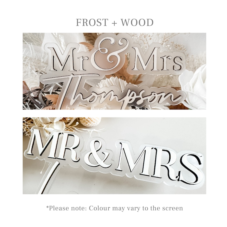 May include: A frosted acrylic cake topper with the text "Mr & Mrs Thompson" in a cursive font. The topper is on a white background with dried flowers.