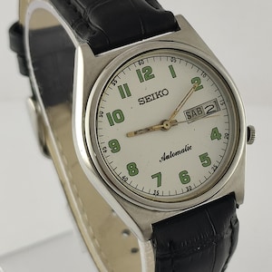 May include: A set of three ceramic mugs with a speckled, matte finish. The mugs are in shades of cream, light gray, and dark gray. Each mug has a simple, minimalist design and a rounded handle.