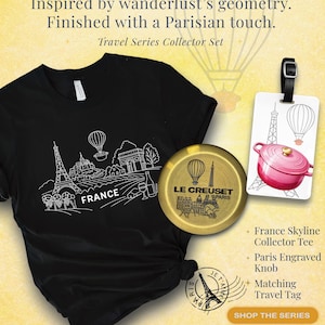 May include: A black t-shirt with a white outline of the Eiffel Tower, hot air balloons, and other French landmarks. A gold-colored Le Creuset knob and a pink travel tag with a pot and Eiffel Tower are also shown.